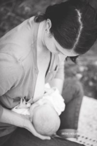 woman breastfeeding black and white